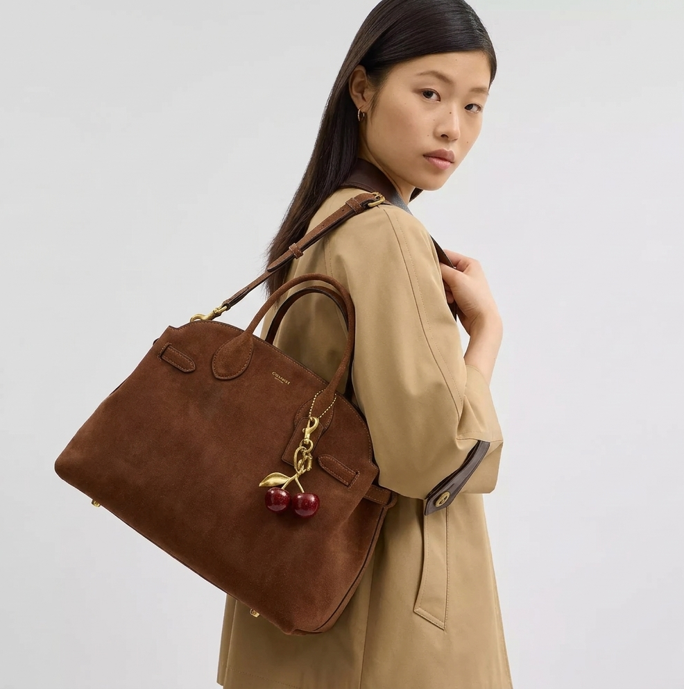 Coach — Female Model Wearing Handbag
